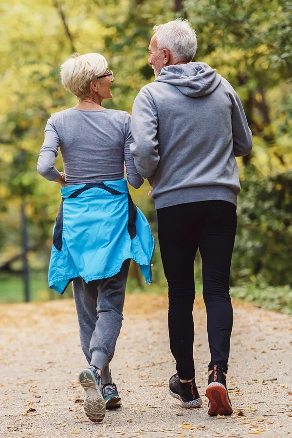 Diabetic-Neuropathy-Treatment A mature couple happily take a brisk walk. Get treatment for Diabetic Neuropathy from ProCare Wellness Institute in Savannah.