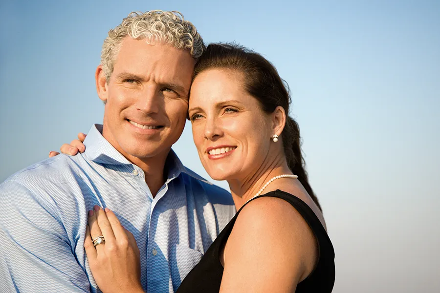 Healthy-Aging-Peptides-Doctor A middle-aged caucasian couple embraces in the sunshine, happy with the healthy aging peptide treatments from ProCare Wellness Institute in Savannah