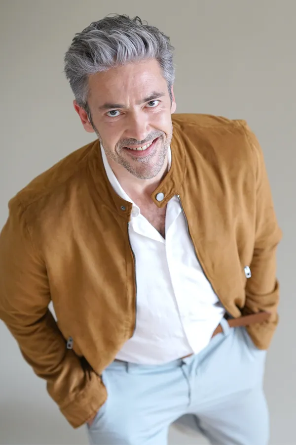 High-Frequency-Electroanalgesic-Therapy-Treatment Distinguished middle-aged man with salt-and-pepper hair, looking directly at the camera with a friendly smile after receiving High Frequency Electroanalgesic Therapy by ProCare Wellness Institute in Savannah.