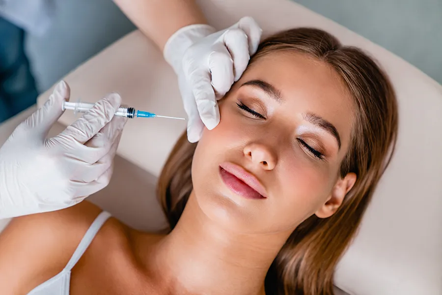 Injectable-Aesthetics-Clinic A woman receives a cosmetic treatment by injection. Get injectable aesthetic treatments from ProCare Wellness Institute in Savannah.