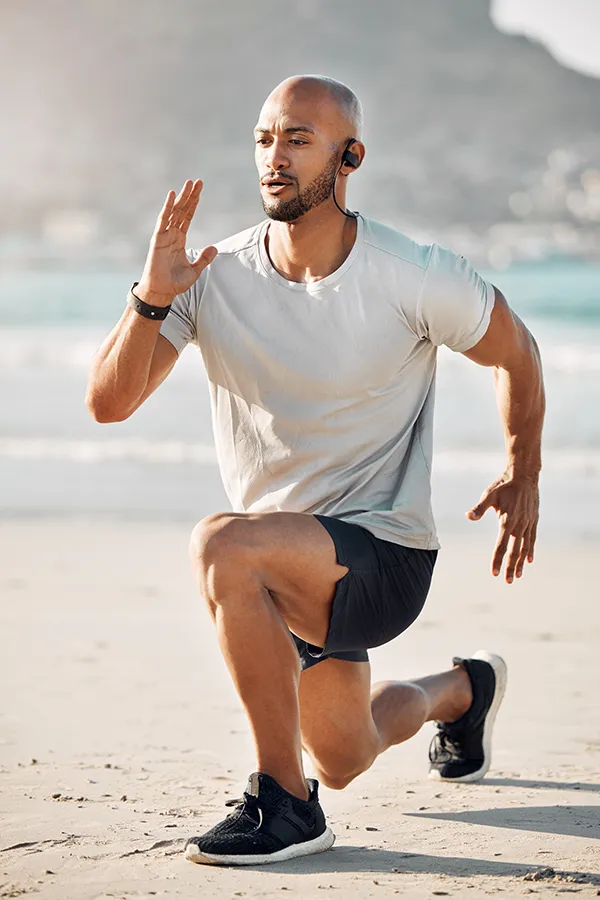MCL-Tears-Treatment A man does lunges on the beach. Get treatment for MCL tears from ProCare Wellness Institute in Savannah.