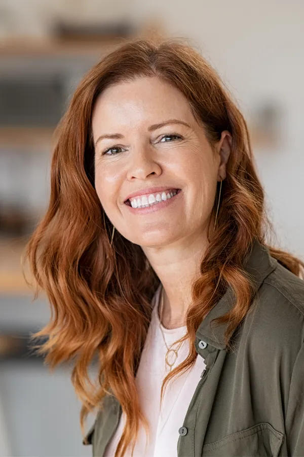 Peptides-for-Hair-Restoration-Treatment A woman with beautiful long red hair smiles due to the success of peptides for hair restoration treatments from ProCare Wellness Institute in Savannah.