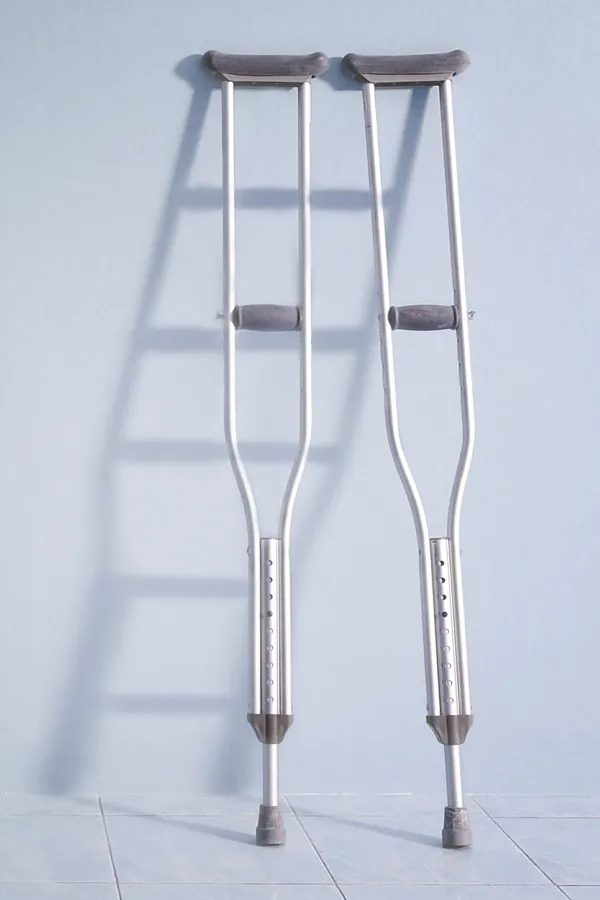 Peptides-for-Healing-and-Recovery-Treatment A pair of crutches rest against a gray wall, representing peptide therapy for healing and recovery from ProCare Wellness Institute in Savannah.
