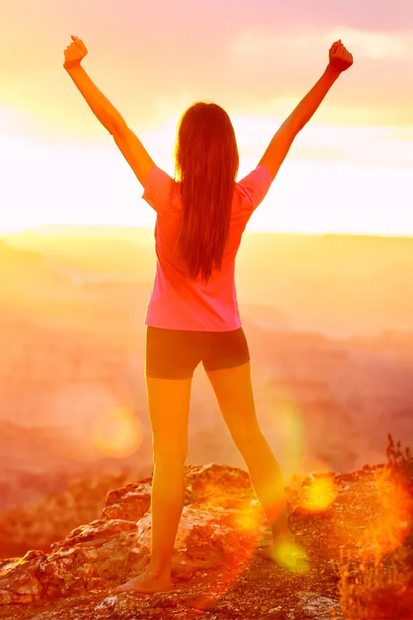 Rotator-Cuff-Treatment A woman raises her arms on a hilltop. Get rotator cuff treatment from ProCare Wellness Institute in Savannah.