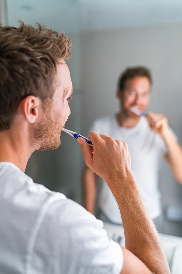 Yellow-Teeth-Treatment A man brushing his teeth. Get treatment for yellow teeth from ProCare Wellness Institute in Savannah.